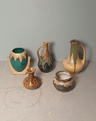 five different types of vases sitting on a table
