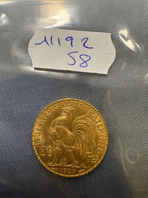 a close up of a gold coin with a label on it