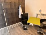 a table and chair in a room with a towel rack