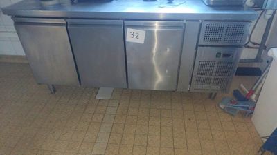 a stainless steel counter with two pots on top of it