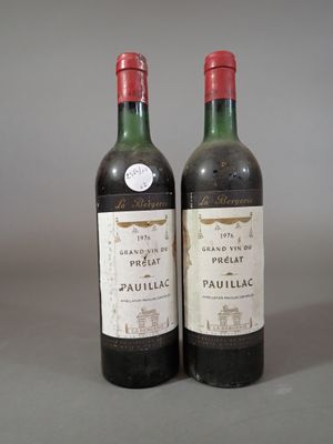 two bottles of red wine sitting next to each other on a table