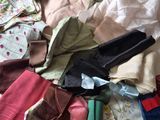 a pile of clothes that is on a bed