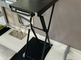 a small black table with a chair on top of it