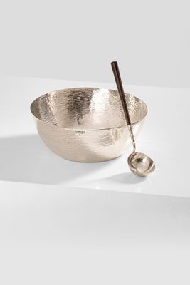 a close up of a metal bowl with a spoon in it