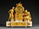 a gold clock sitting on top of a marble table