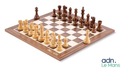 chess pieces on a wooden chess board with a white background