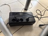a power strip that is connected to a speaker on the floor