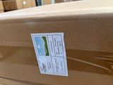 a cardboard box with a sticker on it sitting on a table