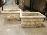 two stone planters sitting on the floor in a room
