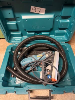 a blue tool box with a hose in it on the floor