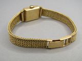 a close up of a gold bracelet with a metal clasp