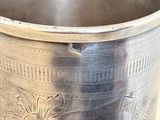 a silver cup that is sitting on a table
