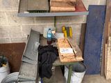 a workbench with tools on it next to a brick wall