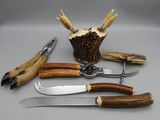 a knife, fork, knife holder, and other tools on a table
