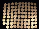 a lot of silver coins on a black surface