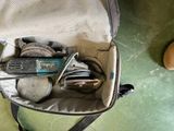 a bag full of tools sitting on the floor