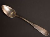 a spoon that is sitting on a black surface