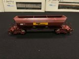a red train car that is on a black table