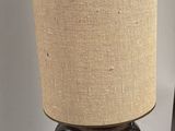 a lamp that is sitting on a table next to a book
