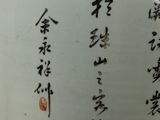 a white vase with asian writing on it sitting on a table