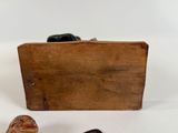 a small wooden box with a pair of shoes next to it
