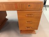 an image of a wooden desk with drawers on it