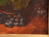 an oil painting of a bunch of grapes and a leaf on a table