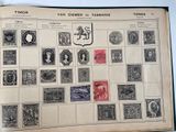 an old book with stamps on it and a picture of a coat of arms