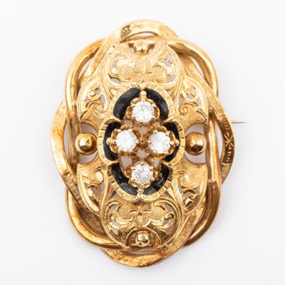 an image of a gold broochle with black and white stones