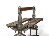 a wooden bench that is sitting on a metal stand