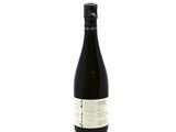 a bottle of wine sitting on top of a white table
