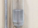 a water dispenser on a wall next to a faucet