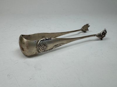 pair of antique silverware spoons on a white surface