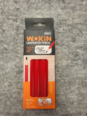a box of waxed pencils sitting on top of a carpet