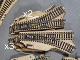 four sets of model train tracks on a table