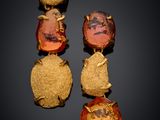 a close up of a pair of earrings on a black surface