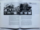 an open book with a black and white photo of a group of people