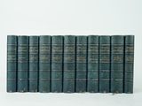 six vieux livres empilés sur une surface blanche