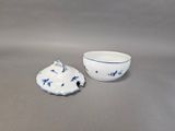 a white bowl and a blue and white bowl on a table