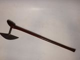 a wooden stick with a wooden handle on a white surface