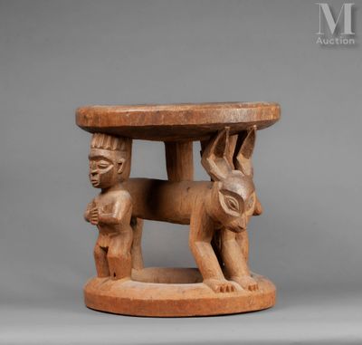 a small wooden table with an elephant and a man on it