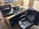 a desk with a laptop and a printer on it