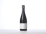 the bottle of wine is sitting on a white surface