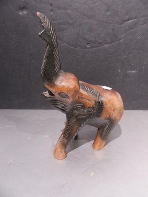 an elephant figurine that is standing on a table