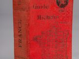 a red book sitting on top of a white table