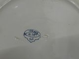a white plate with a blue and white design on it