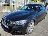 the bmw 3 series sedan is parked in front of a white fence