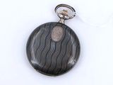 an image of a close up of a pocket watch on a white surface