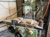 a machine that is working on a piece of wood