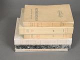 three books stacked on top of each other on a table